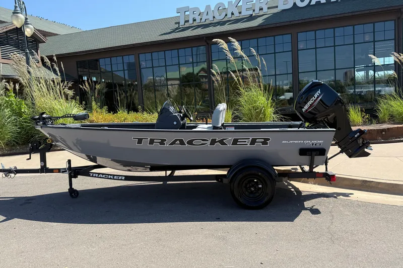 The Image of 2027 Tracker Super Guide V-16 SC boat on trailer outside Tracker Boats dealership. - 0