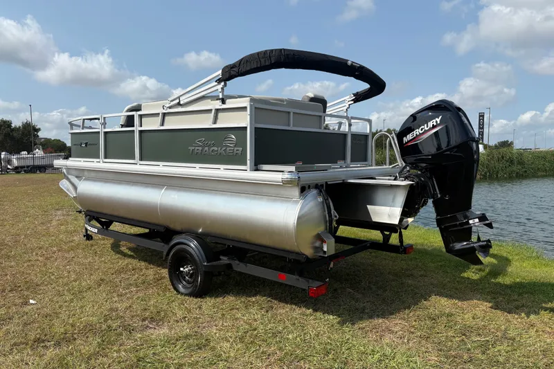 Slide: The Image of 2027 Sun Tracker Bass Buggy 16 XL Select pontoon boat with Mercury engine by a lake. - 61