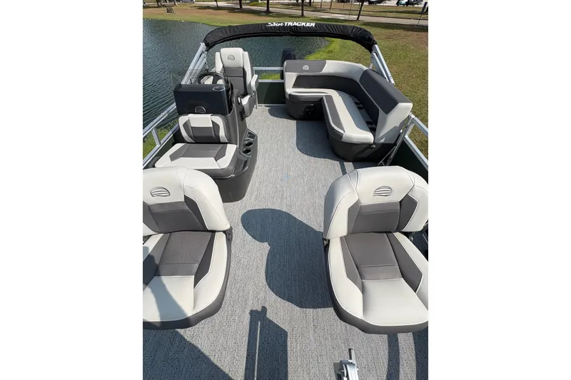 Slide: The Image of 2027 Sun Tracker Bass Buggy 16 XL Select pontoon boat interior with seating and helm. - 68