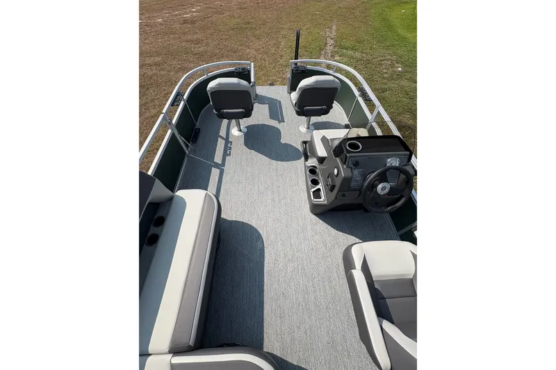 Slide: The Image of 2027 Sun Tracker Bass Buggy 16 XL Select pontoon boat interior with seating and steering console. - 65