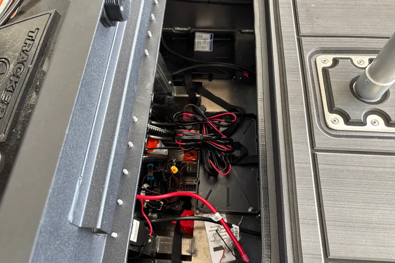 Slide: The Image of Interior view of a 2027 Tracker Savage 215 boat showing wiring and storage compartment. - 35