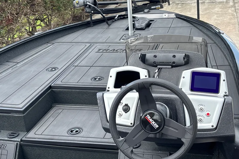Slide: The Image of 2027 Tracker Savage 215 boat dashboard with steering wheel and electronic displays. - 15
