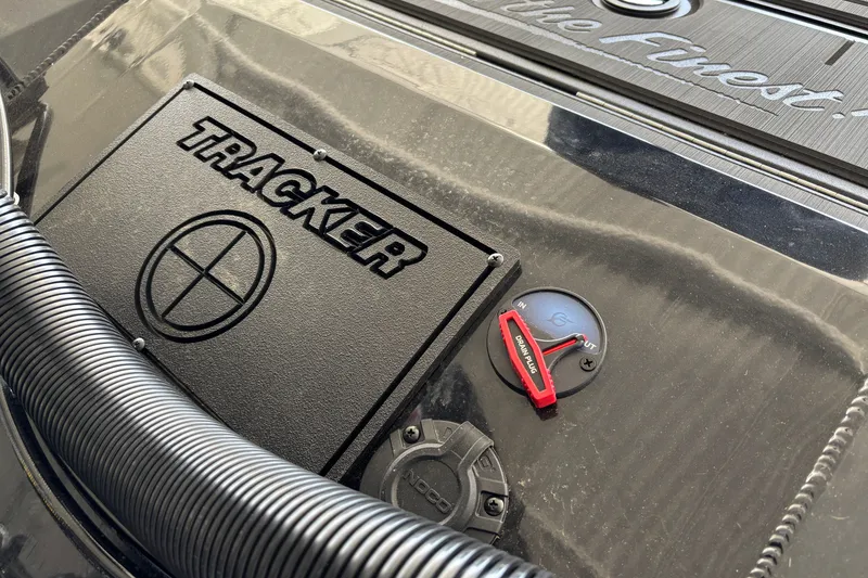 Slide: The Image of Close-up of 2027 Tracker Savage 215 boat dashboard with branding and controls. - 33