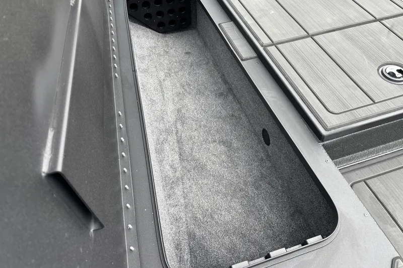Slide: The Image of Interior storage compartment of 2027 Tracker Savage 215 boat, featuring sleek design and durable materials. - 25
