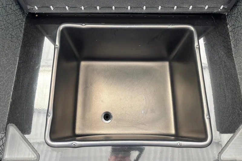 Slide: The Image of Livewell compartment in a 2027 Tracker Savage 215 boat, featuring a sleek black interior. - 30
