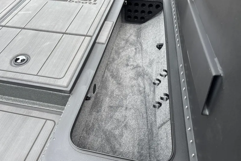 Slide: The Image of Interior view of 2027 Tracker Savage 215 boat storage compartment. - 27