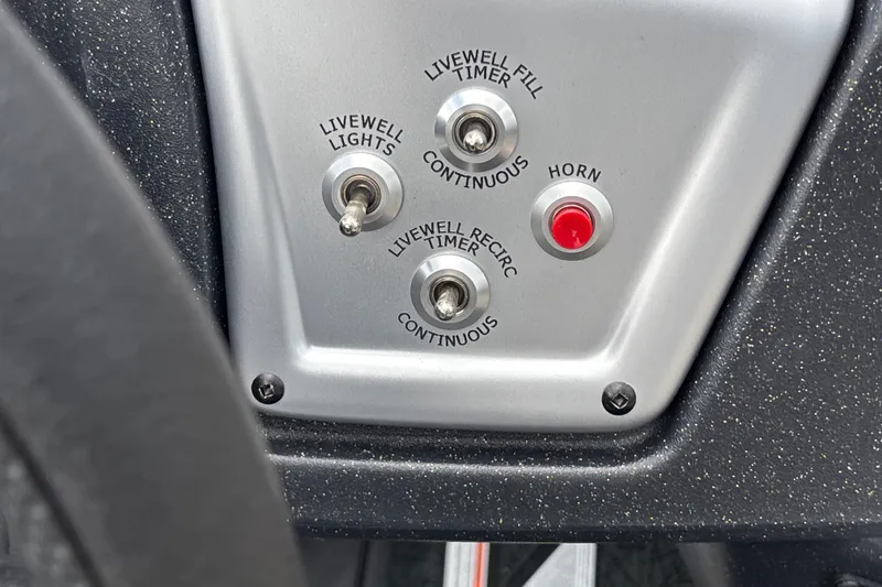 Slide: The Image of Control panel of 2027 Tracker Savage 215 boat with switches and horn button. - 19