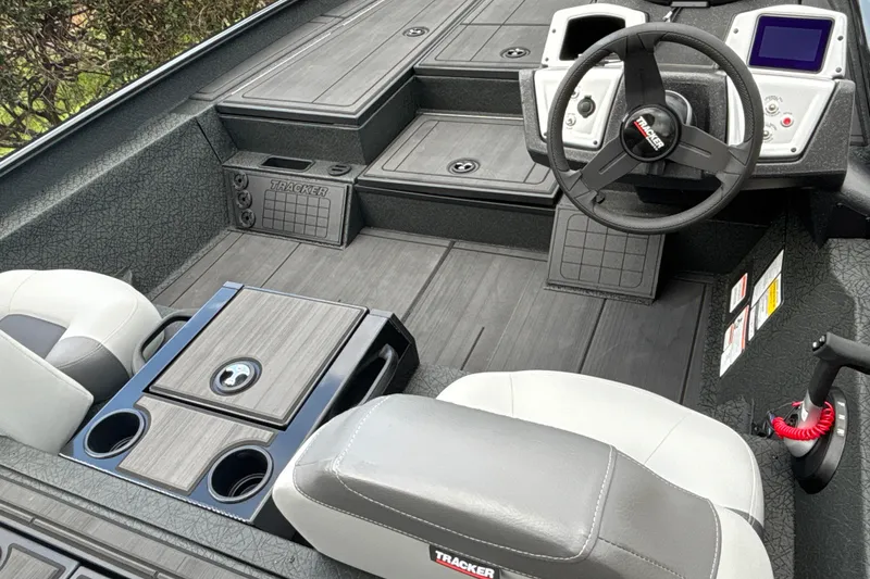 Slide: The Image of Interior of 2027 Tracker Savage 215 boat with steering wheel and seating. - 16