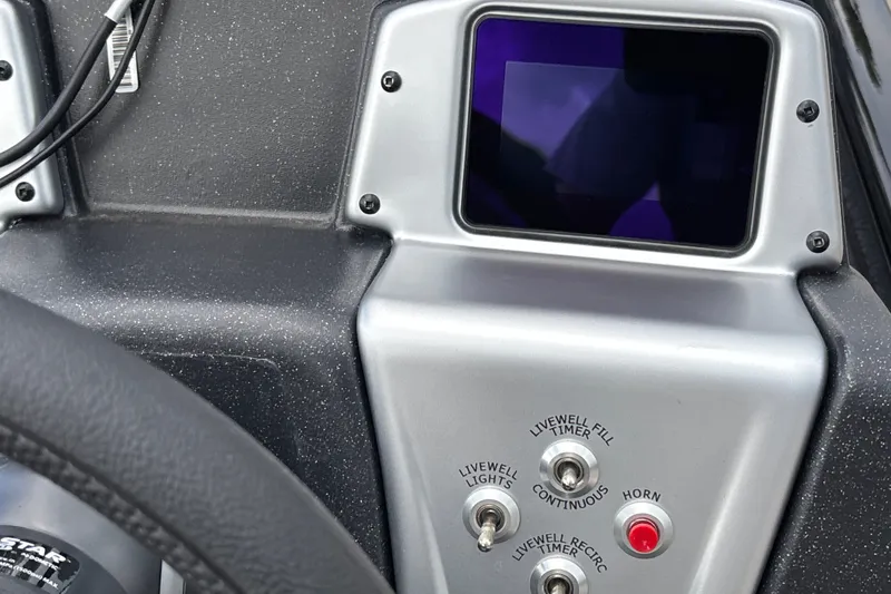 Slide: The Image of Control panel of 2027 Tracker Savage 215 boat with switches and display screen. - 20