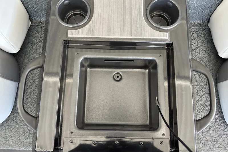Slide: The Image of Center console of 2027 Tracker Savage 215 with cup holders and storage compartment. - 31