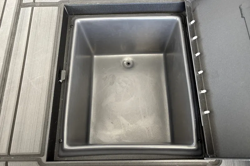 Slide: The Image of Open storage compartment in 2027 Tracker Savage 215 boat. - 32