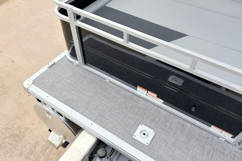 Slide: The Image of 2027 Sun Tracker Party Barge 22 RF XP3 deck with railing and textured flooring. - 50