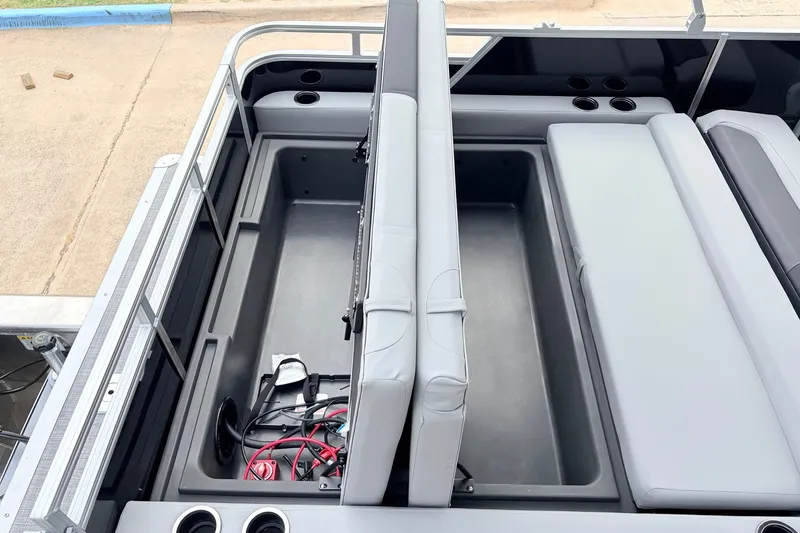 Slide: The Image of 2027 Sun Tracker Party Barge 22 RF XP3 interior storage compartment with seating and cup holders. - 48