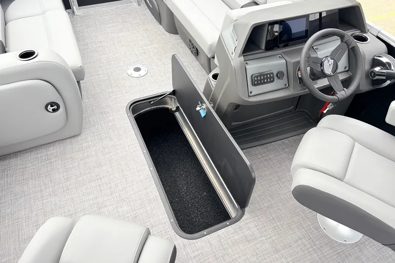 Slide: The Image of Interior of 2027 Sun Tracker Party Barge 22 RF XP3 with open storage compartment. - 24