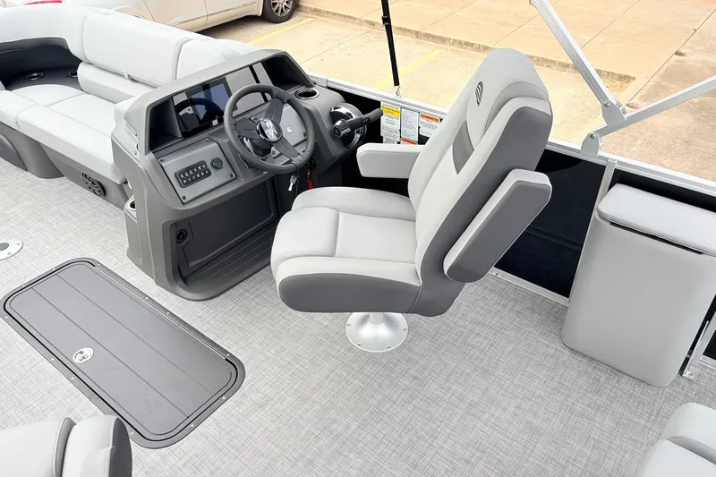 Slide: The Image of 2027 Sun Tracker Party Barge 22 RF XP3 interior with captain's chair and steering console. - 28