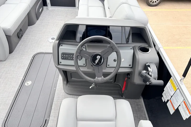 Slide: The Image of 2027 Sun Tracker Party Barge 22 RF XP3 helm with steering wheel and controls. - 29