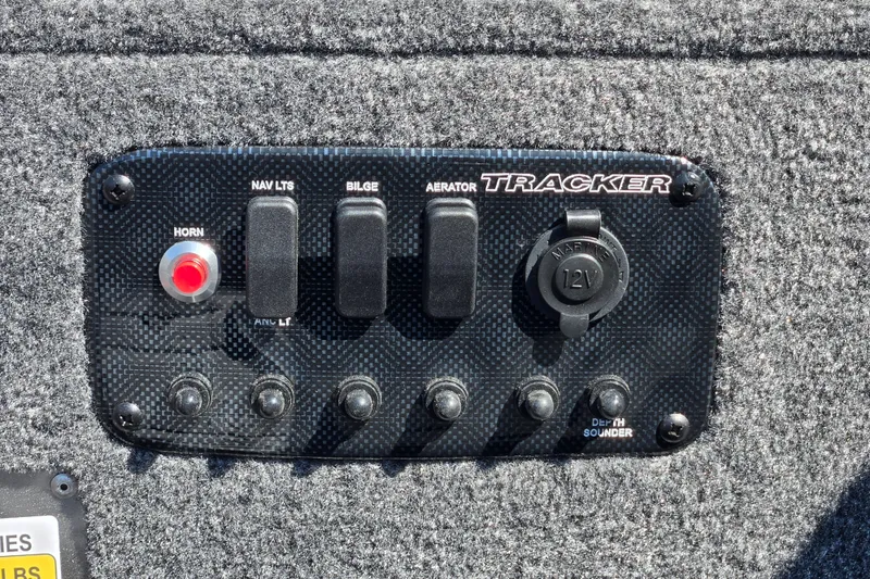 Slide: The Image of Control panel of 2027 Tracker Panfish 17 boat with switches and 12V outlet. - 16