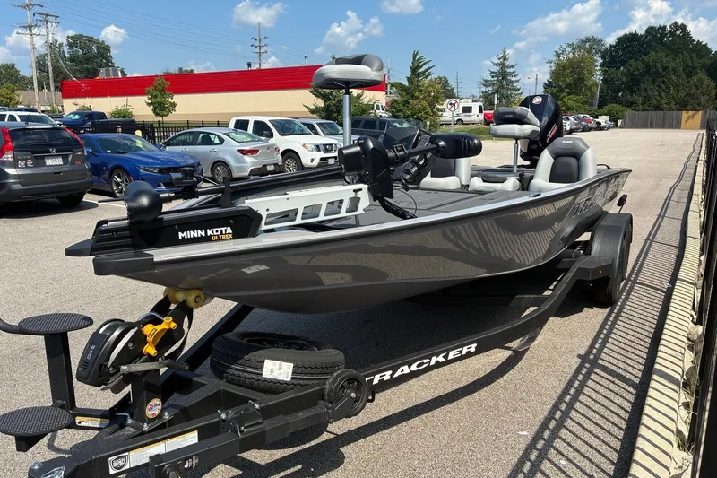 The Image of 2027 Tracker Savage 215 boat with Minn Kota Ultrex motor in parking lot. - 0