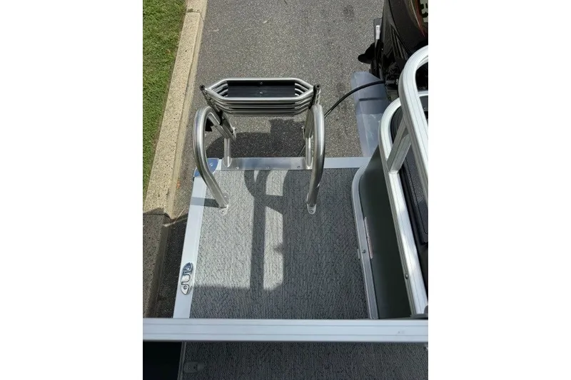 Slide: The Image of 2027 Sun Tracker Bass Buggy 18 DLX boat ladder and deck, viewed from above. - 17