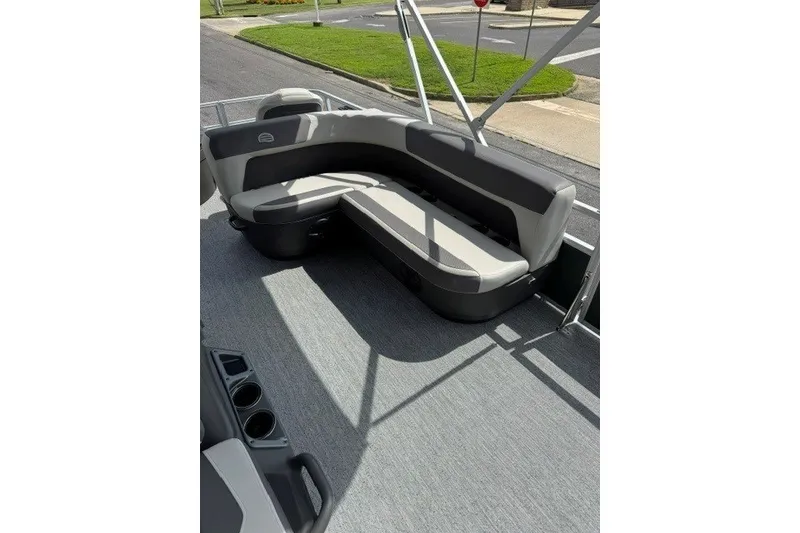 Slide: The Image of 2027 Sun Tracker Bass Buggy 18 DLX pontoon boat interior with gray seating and carpet. - 13