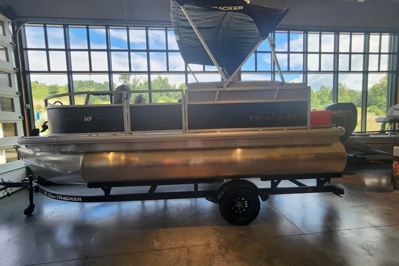 The Image of 2027 Sun Tracker Bass Buggy 16 XL Select pontoon boat in showroom. - 0
