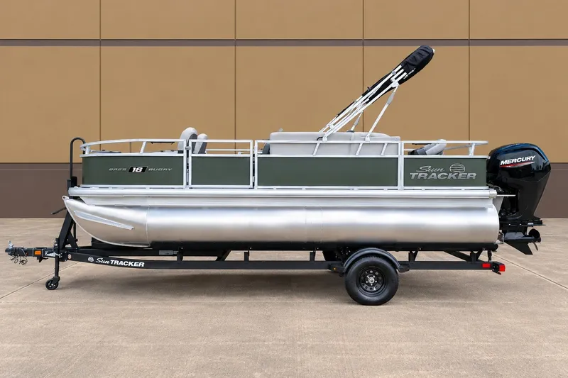 The Image of 2027 Sun Tracker Bass Buggy 18 DLX pontoon boat on trailer, side view. - 0