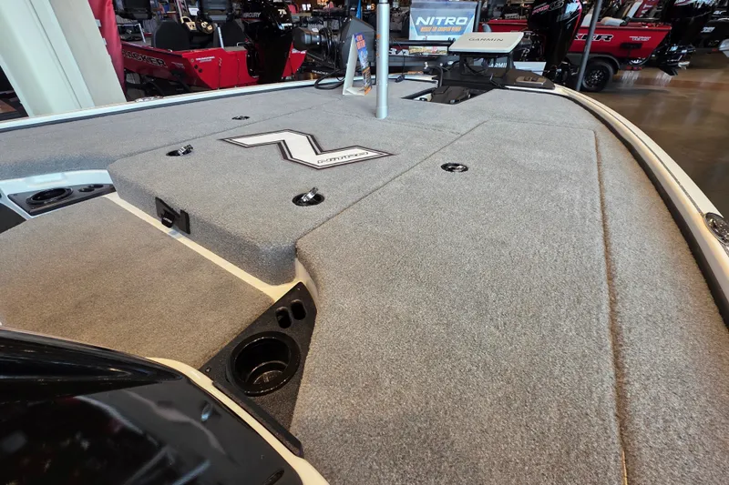 Slide: The Image of 2027 Nitro Z18 XL Pro boat deck with carpeted surface and storage compartments. - 2