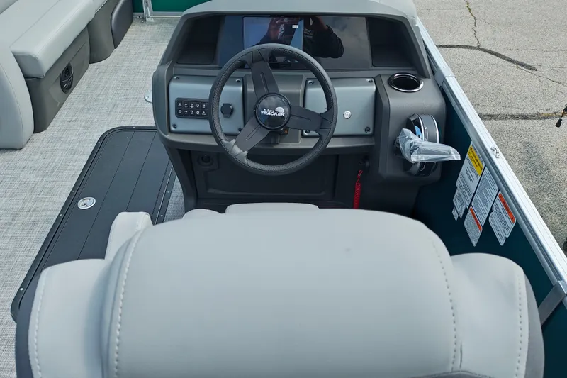 Slide: The Image of 2027 Sun Tracker Party Barge 22 RF XP3 steering console with modern controls and seating. - 20