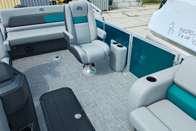 Slide: The Image of Interior of 2027 Sun Tracker Party Barge 22 RF XP3 with gray seating and teal accents. - 15