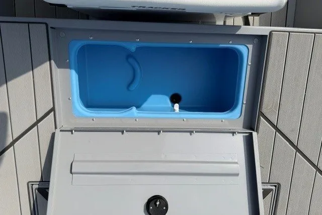 Slide: The Image of 2027 Tracker Bass Tracker Classic CC livewell with open lid, showcasing interior design. - 15