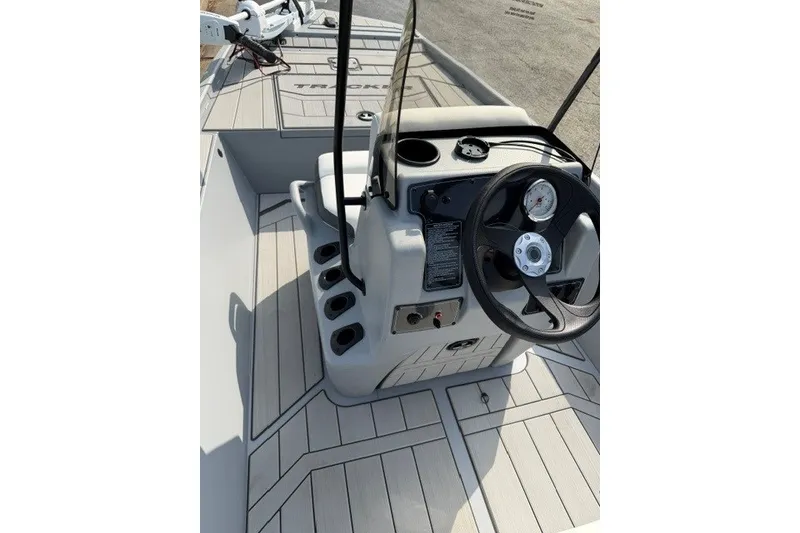 Slide: The Image of 2027 Tracker Bass Tracker Classic CC boat console with steering wheel and controls. - 13