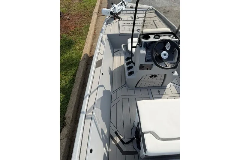 Slide: The Image of 2027 Tracker Bass Tracker Classic CC boat interior with steering console and seating. - 17