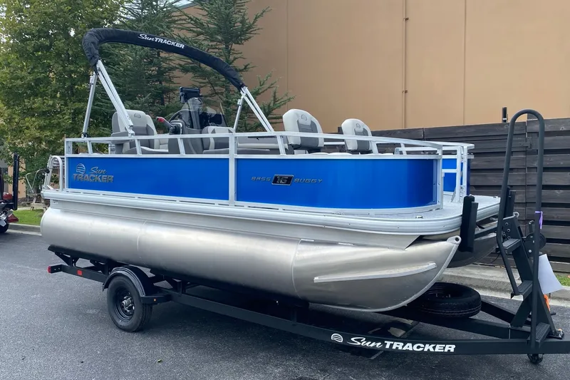 The Image of 2027 Sun Tracker Bass Buggy 16 XL Select pontoon boat on trailer. - 0
