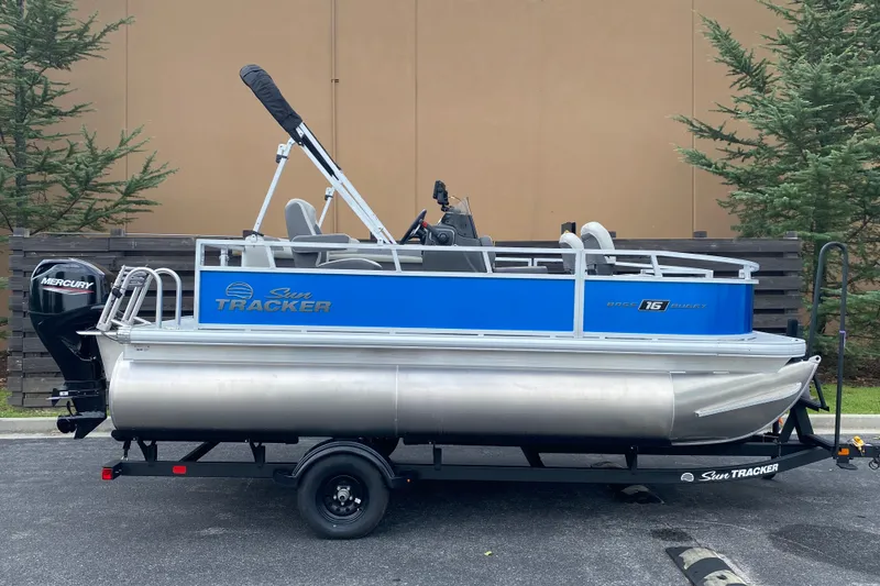 The Image of 2027 Sun Tracker Bass Buggy 16 XL Select pontoon boat on trailer, side view. - 0