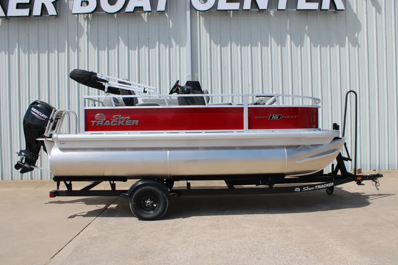 The Image of 2027 Sun Tracker Bass Buggy 16 XL Select pontoon boat on trailer, side view. - 0