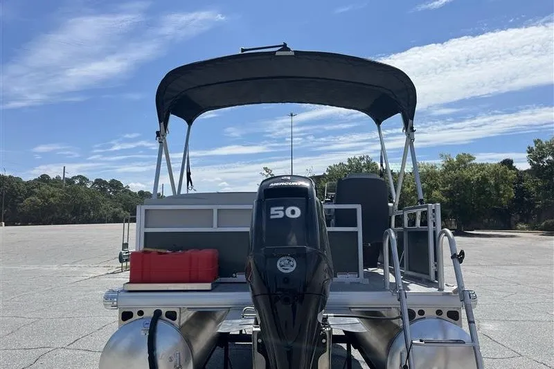 Slide: The Image of 2027 Sun Tracker Bass Buggy 16 XL Select pontoon boat with Mercury 50 engine in parking lot. - 15