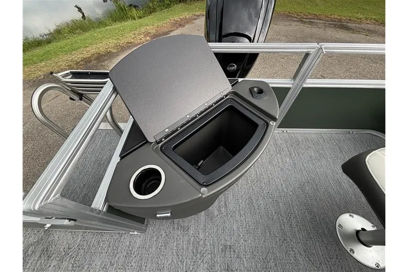 Slide: The Image of 2027 Sun Tracker Bass Buggy 18 DLX boat interior with storage compartment and cup holder. - 29