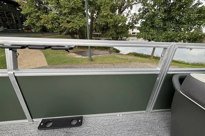 Slide: The Image of 2027 Sun Tracker Bass Buggy 18 DLX pontoon boat interior with lake view. - 18