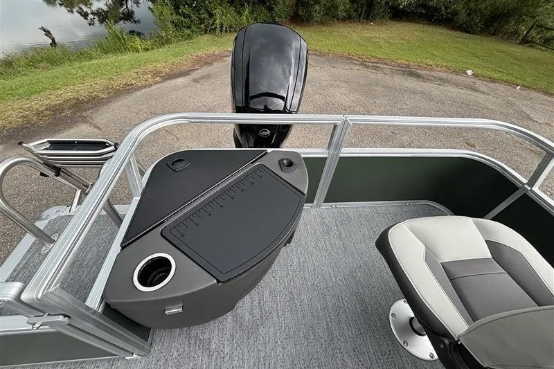 Slide: The Image of 2027 Sun Tracker Bass Buggy 18 DLX pontoon boat interior with seating and motor. - 28