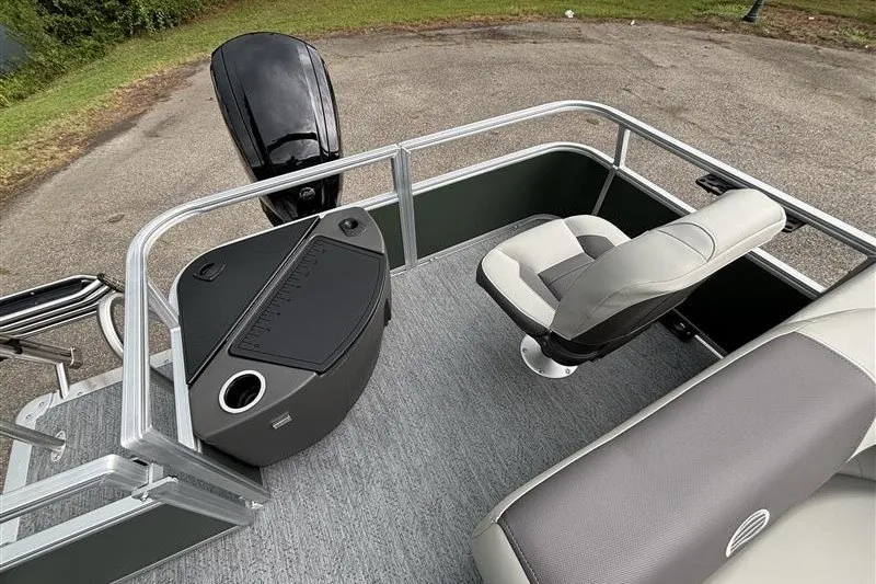 Slide: The Image of 2027 Sun Tracker Bass Buggy 18 DLX pontoon boat interior with seating and console. - 27