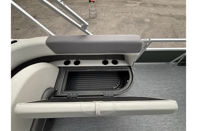 Slide: The Image of 2027 Sun Tracker Bass Buggy 18 DLX boat seat storage compartment with cup holders. - 21