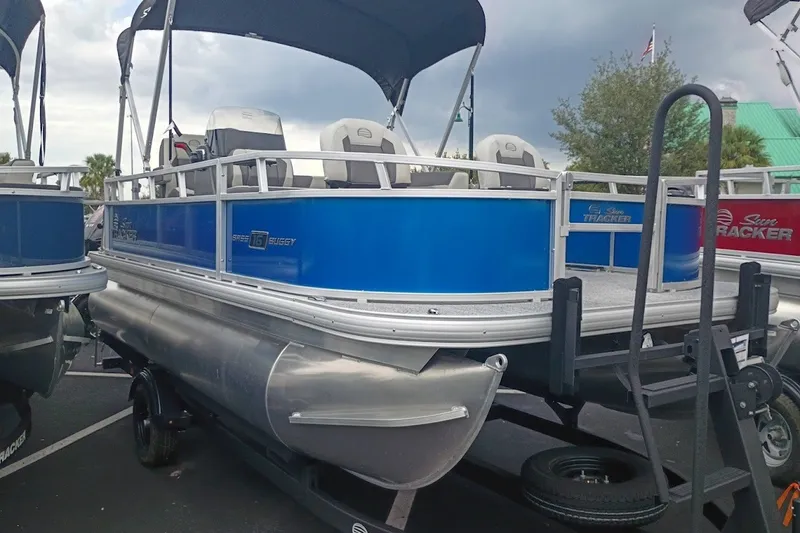 The Image of 2027 Sun Tracker Bass Buggy 16 XL Select pontoon boat with blue exterior on display. - 0