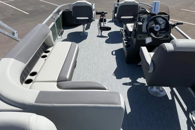 Slide: The Image of Interior of 2027 Sun Tracker Fishin' Barge 22 XP3, featuring seating and steering console. - 15