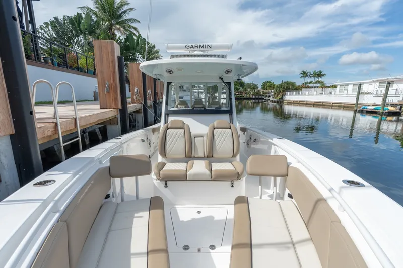 Slide: The Image of 2020 Everglades 355 Center Console boat docked by a serene waterfront. - 20