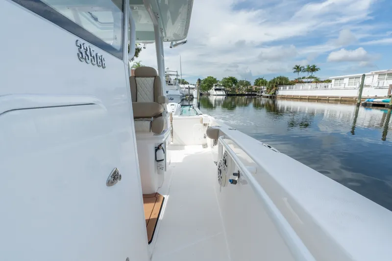 Slide: The Image of 2020 Everglades 355 Center Console boat docked on a calm waterway. - 22