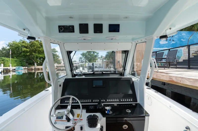 Slide: The Image of Cockpit view of 2020 Everglades 355 Center Console boat, featuring modern navigation controls. - 11