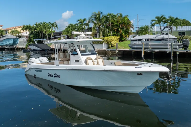 Slide: The Image of 2020 Everglades 355 Center Console boat docked in a scenic marina setting. - 3