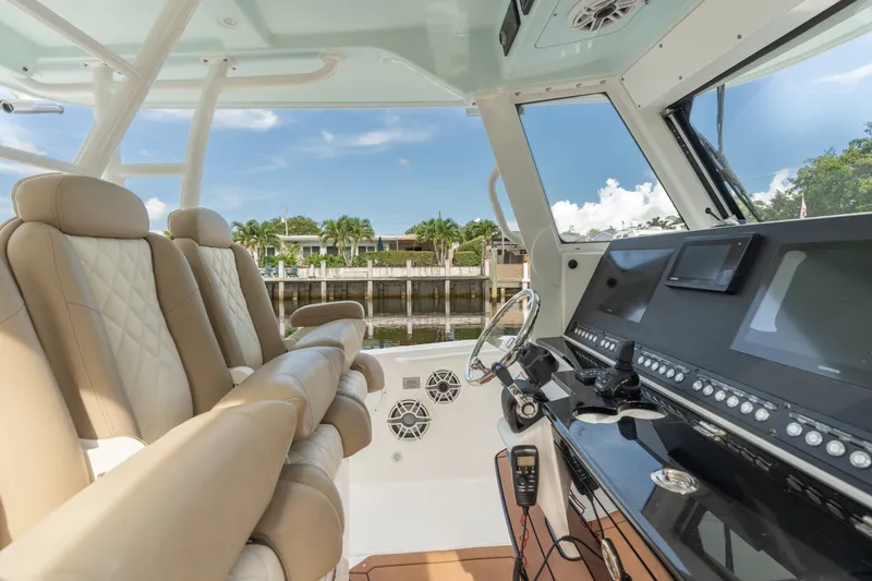 Slide: The Image of Interior view of 2020 Everglades 355 Center Console boat with luxurious seating and advanced controls. - 9