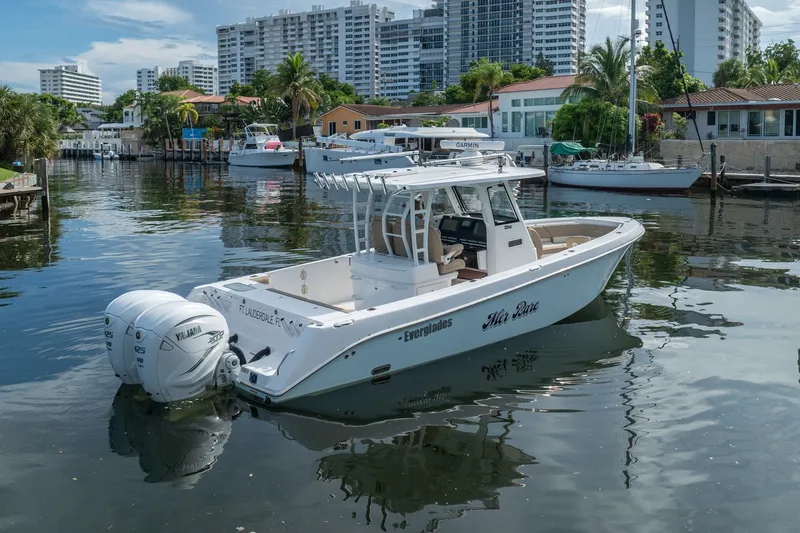 Slide: The Image of 2020 Everglades 355 Center Console boat docked in a scenic marina setting. - 5