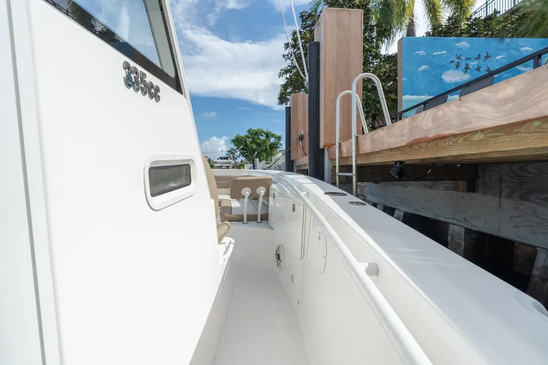 Slide: The Image of 2020 Everglades 355 Center Console boat docked, showcasing sleek design and spacious deck. - 16